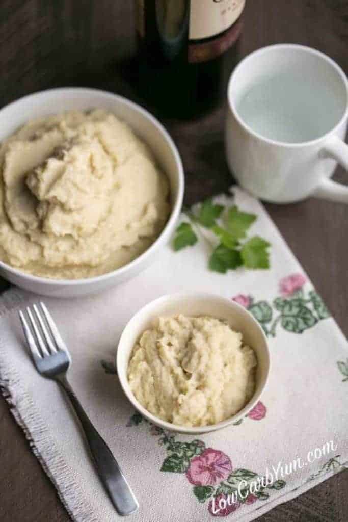 mashed cauliflower and garlic root in serving bowls