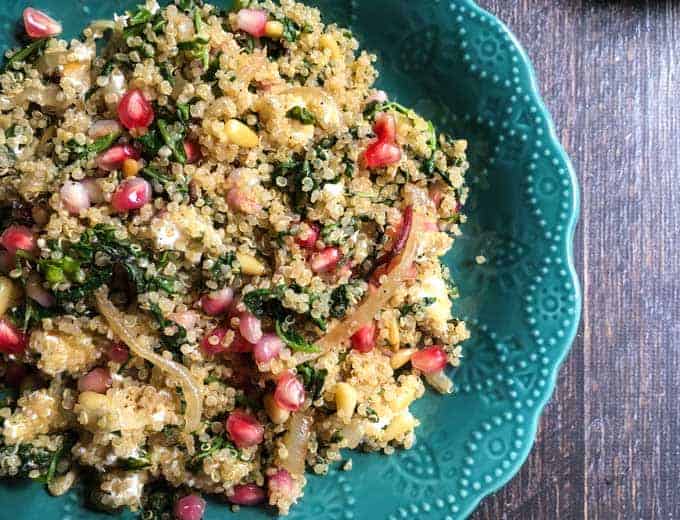 quinoa pilaf with colorful pomegranate and kale