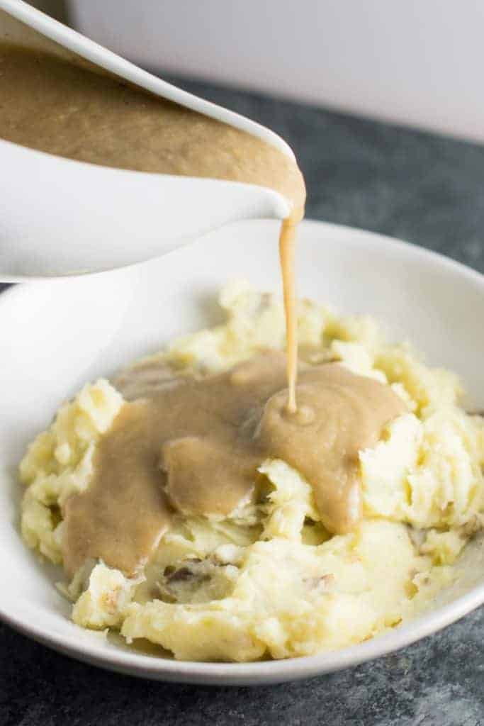 vegetarian gravy being poured onto mashed potatoes