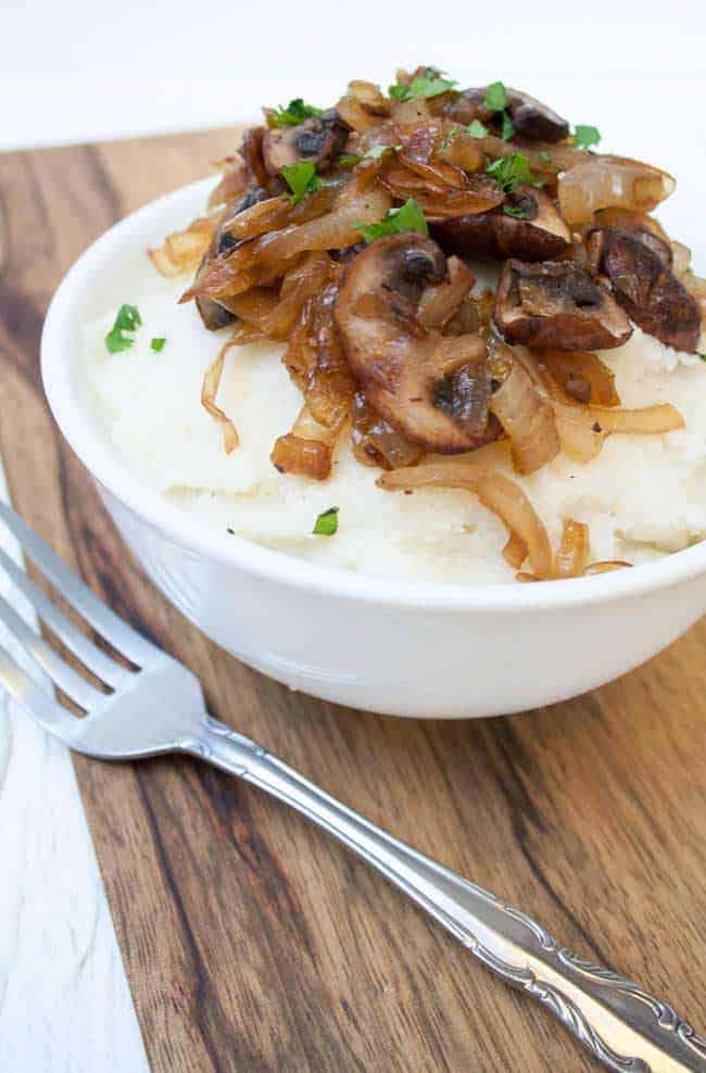 vegan mashed cauliflower with caramelized onions and mushrooms on top
