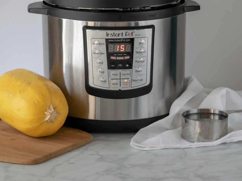 instant pot with spaghetti squash and water to cook in a hurry