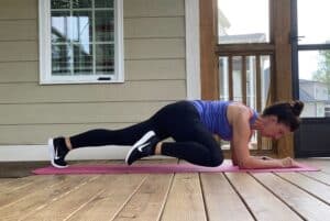 woman doing low side plank with knee to elbow